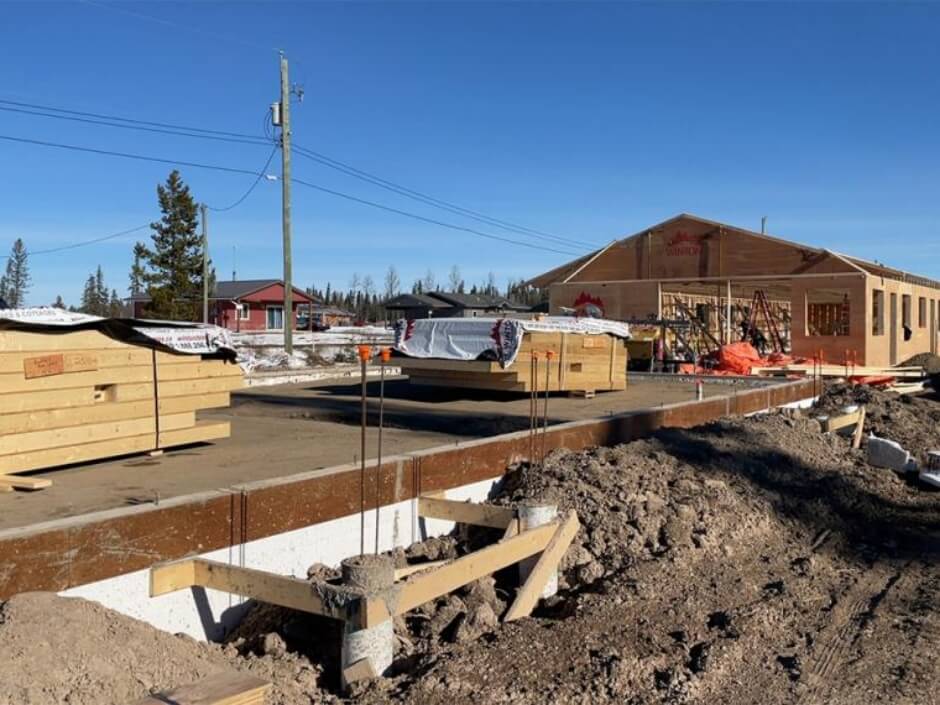 foundation ready with wall panels stacked for assembly