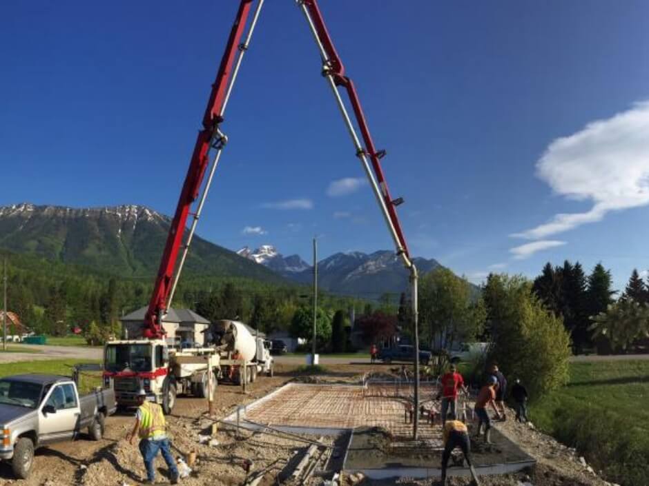 foundation pouring on prepped lot with mountains in the background